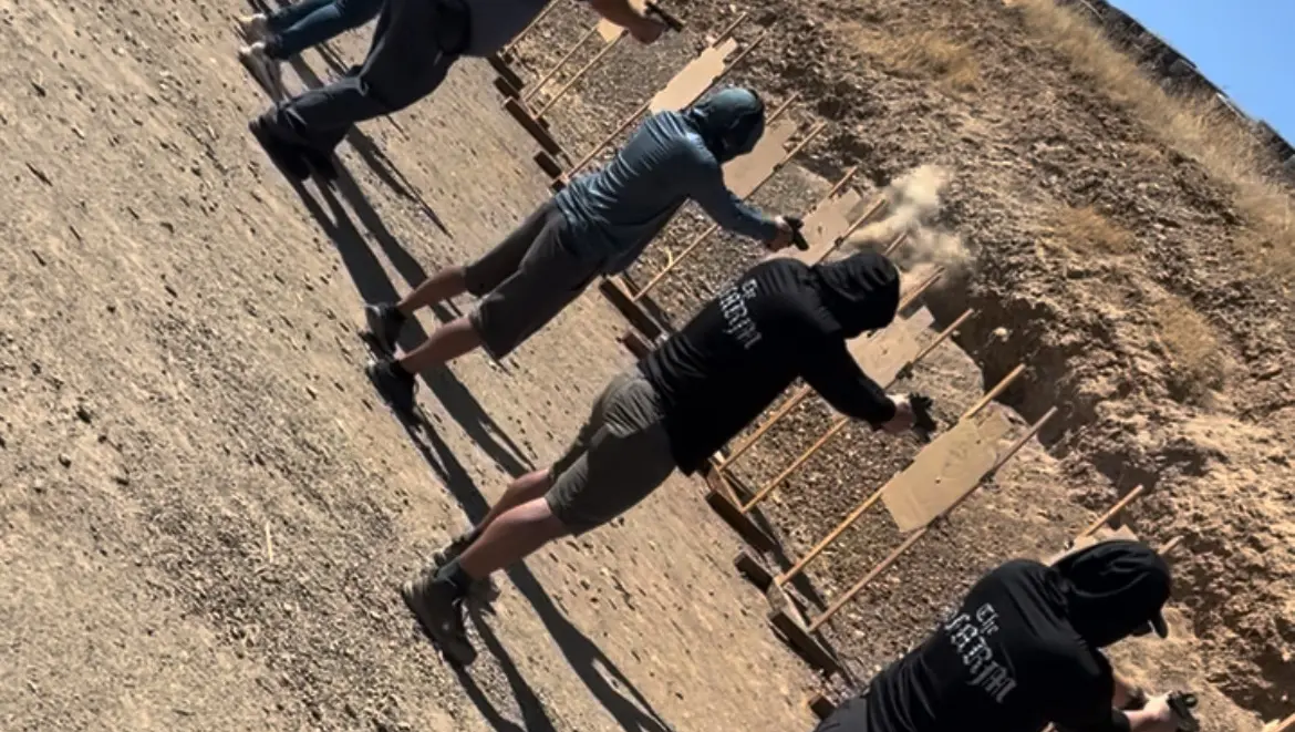 Group of people shooting at cardboard targets
