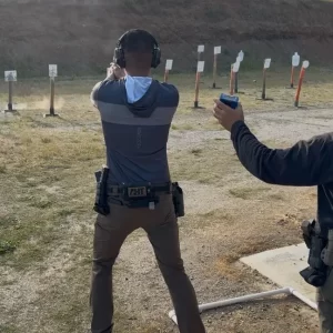 Two men shooting steel targets at a range