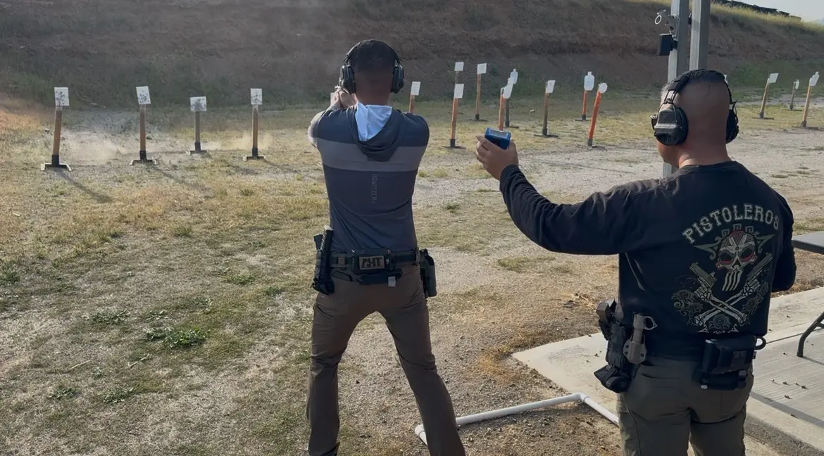Two men shooting steel targets at a range